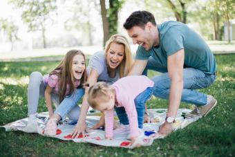 family playing twister game at the park