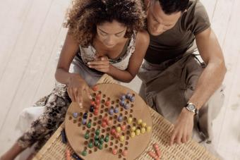 Man and Woman Playing Chinese Checkers