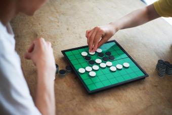 Couple playing Reversi (Othello) board game
