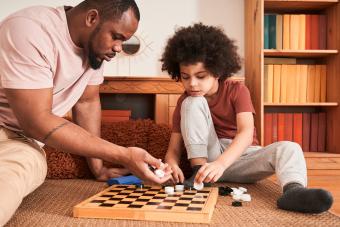 Father and son playing checkers