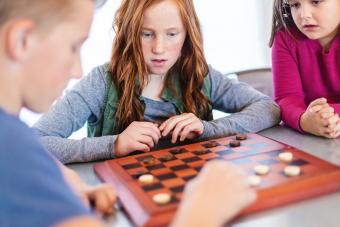 Three Siblings Playing checkers