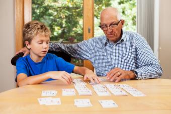 Grandfather Teaching Grandson Solitaire Playing Card Game