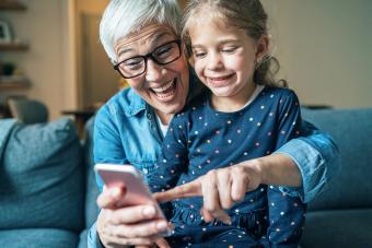 grandmother and granddaughter playing smartphone