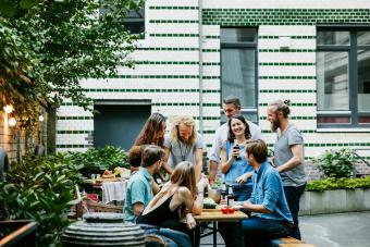 Young Group Of Friends Gathered Around Table