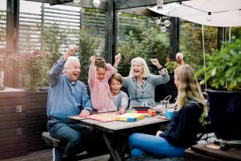 Cheerful family playing board game