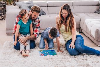 young family playing board game