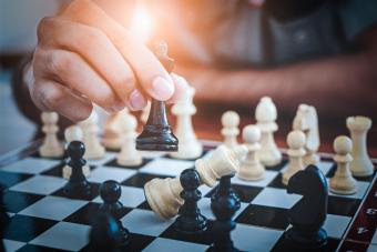 Hand of man playing chess game