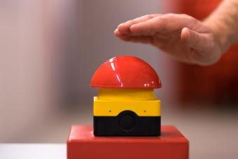 A hand about to press buzzer