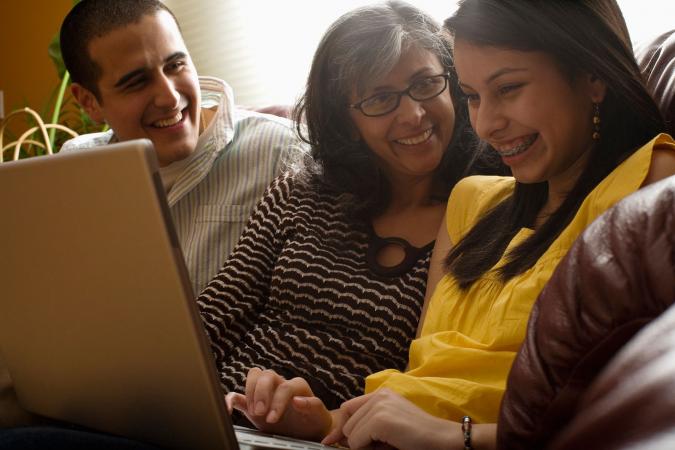 Family playing game on laptop