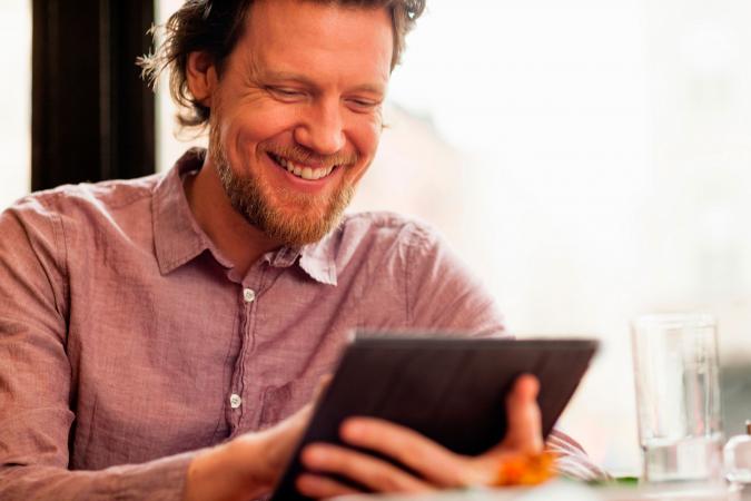 Man playing game on digital tablet