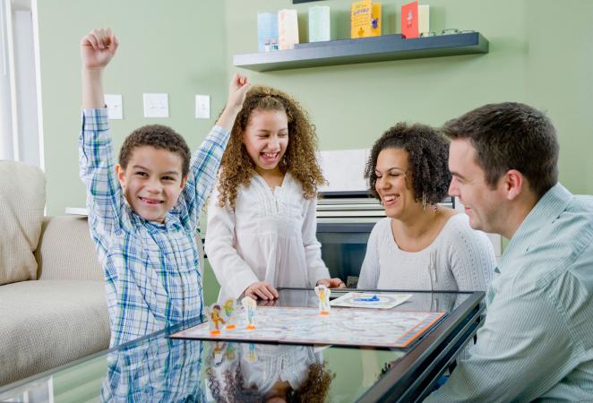 Family playing a board game together