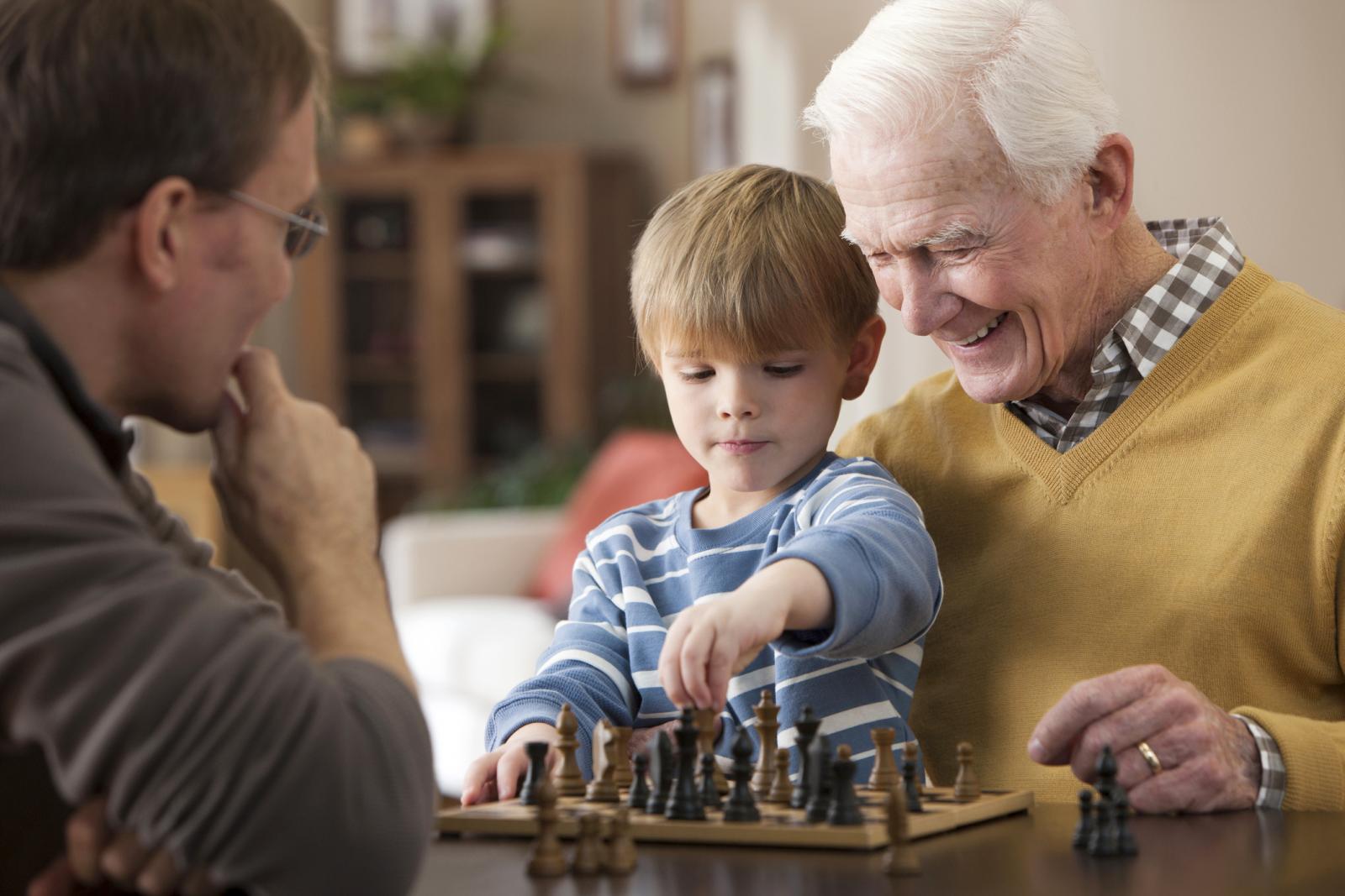 Grandfather and grandson playing chess