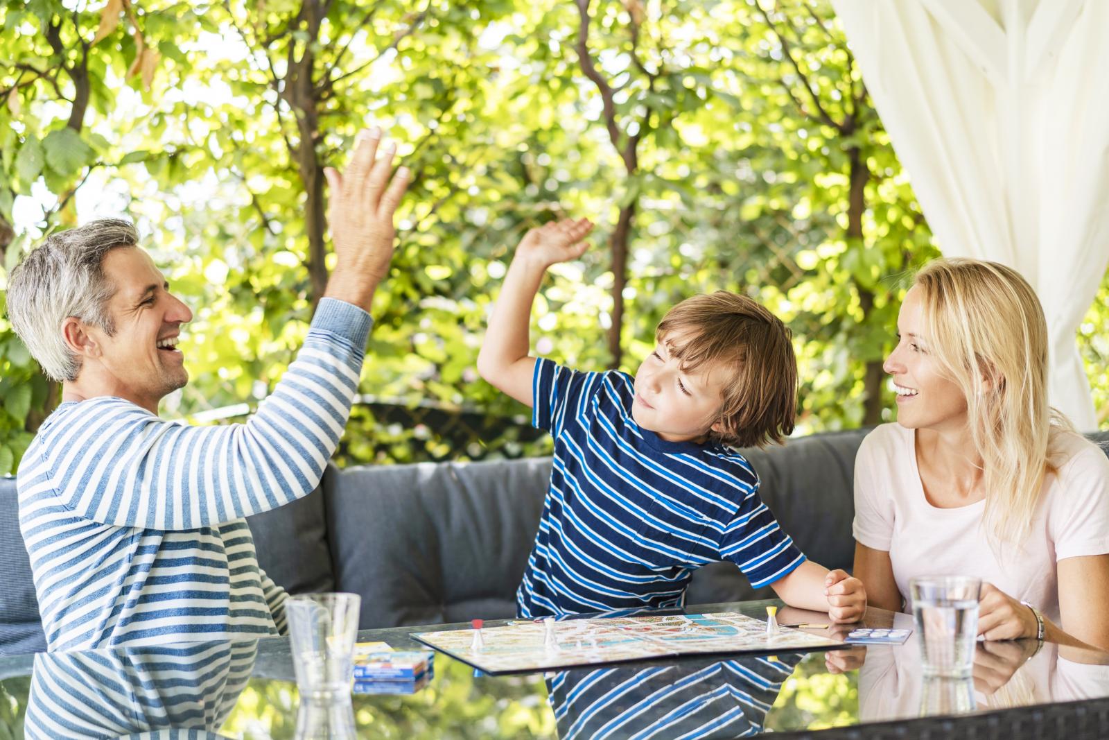 Happy father and son high fiving after winning a game