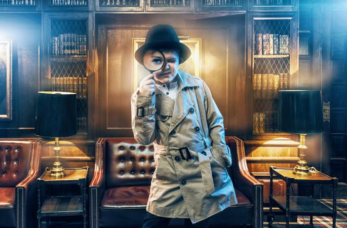 Young detective in room looking for clues
