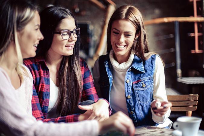 Three women playing board game