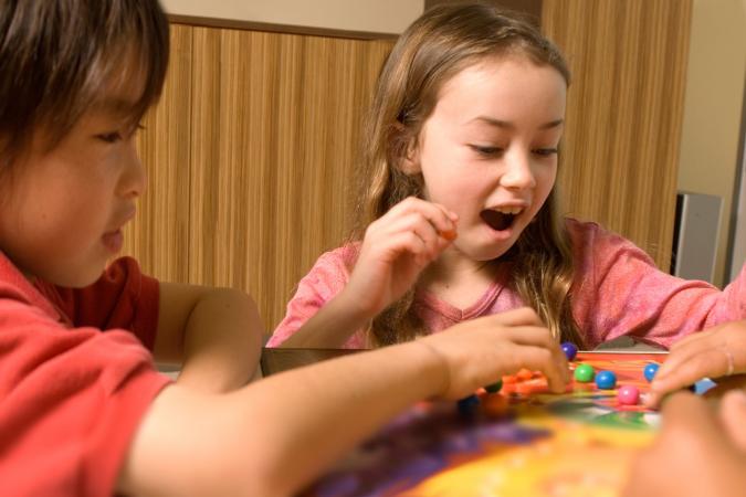 Kids playing marble board game