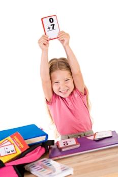 child holding up flash cards