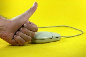 Computer mouse and hand giving thumbs up