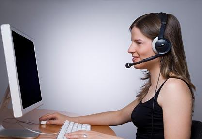 girl at computer with phone