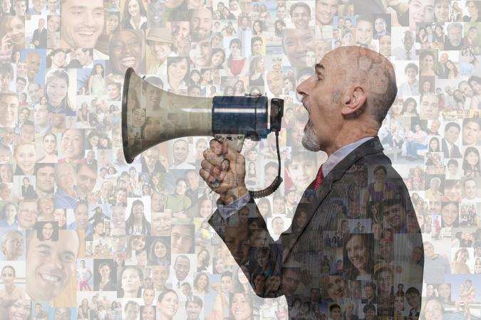 Businessman shouting in megaphone