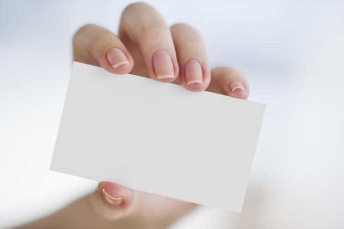 Hand holding a blank business card