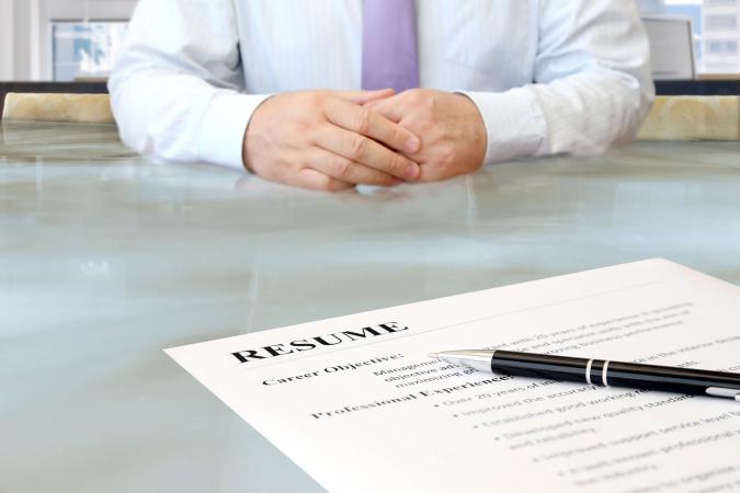Man sitting at desk with resume