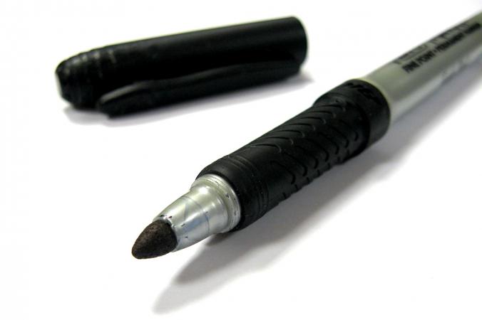 Black permanent pen on white background