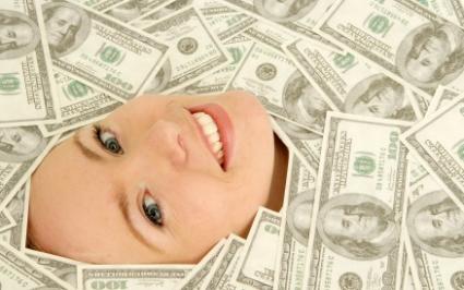 Female employee under a pile of bonus money