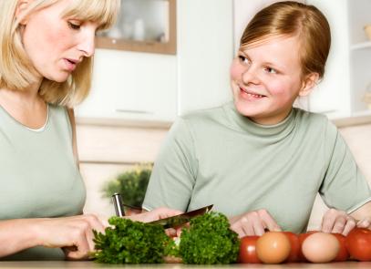 Mother and daughter preparing vegetarian food