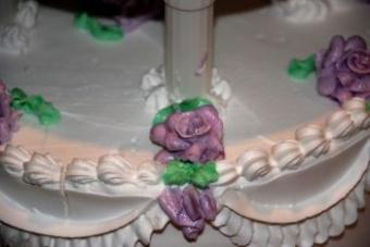 A buttercream rose on a wedding cake