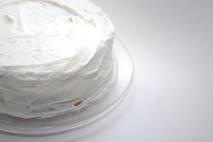 A cake with white frosting