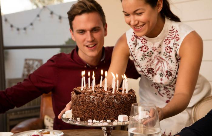 Friends celebrating with chocolate birthday cake