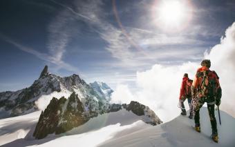 Hikers standing on snowy mountain top