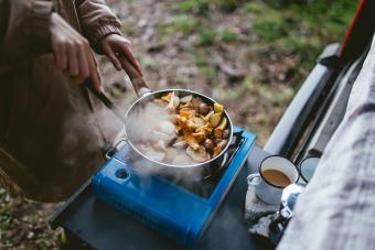 Making food on camping stove in nature