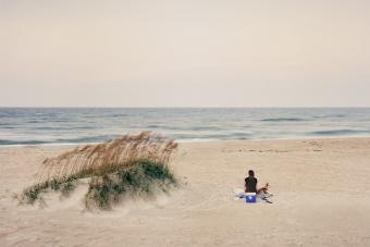 woman sitting on Ocracoke Island beach