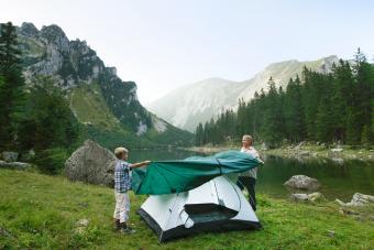 Father and son pitching tent together