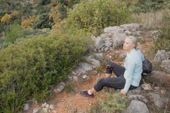 Woman hiker rests on trail