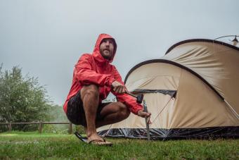 Man caught in a rainstorm while camping