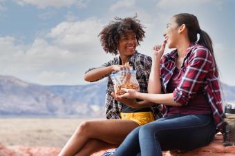 friends backpacking and eating a snack