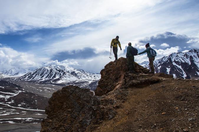 Group hiking an Alaskan mountain range