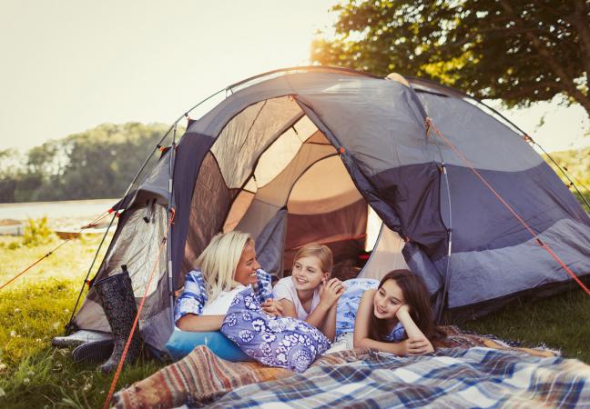 woman and kids camping with tent