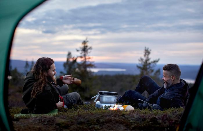 Hikers chatting in front of tent