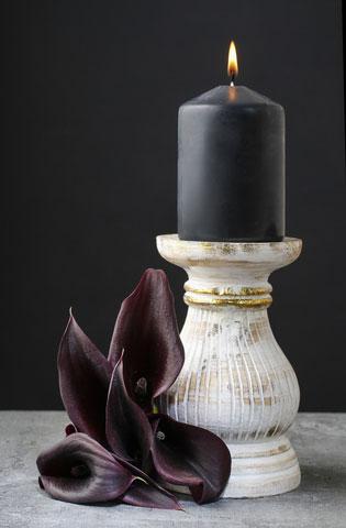 black candle and calla flower