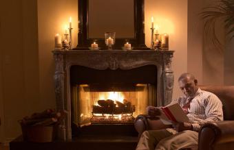 Mature man reading by fire