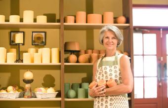 business owner with candle display