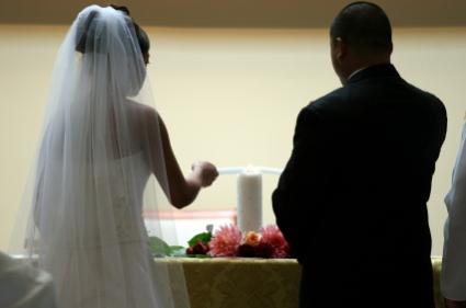 Lighting the unity candle at a wedding.