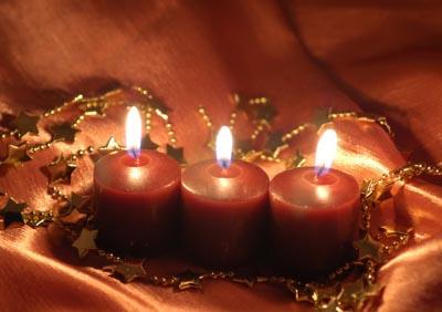 three red candles in a handmade holder