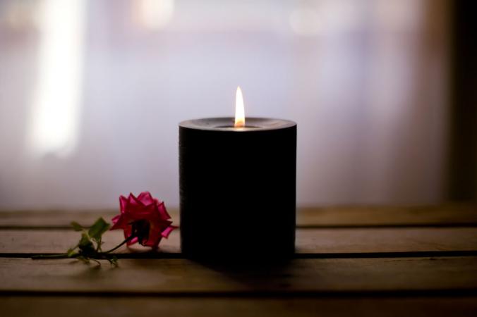 black candle with red rose