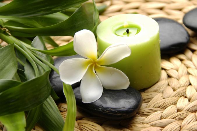 Green candle with Frangipani flower