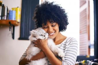 Young woman enjoying a cuddle with her cat